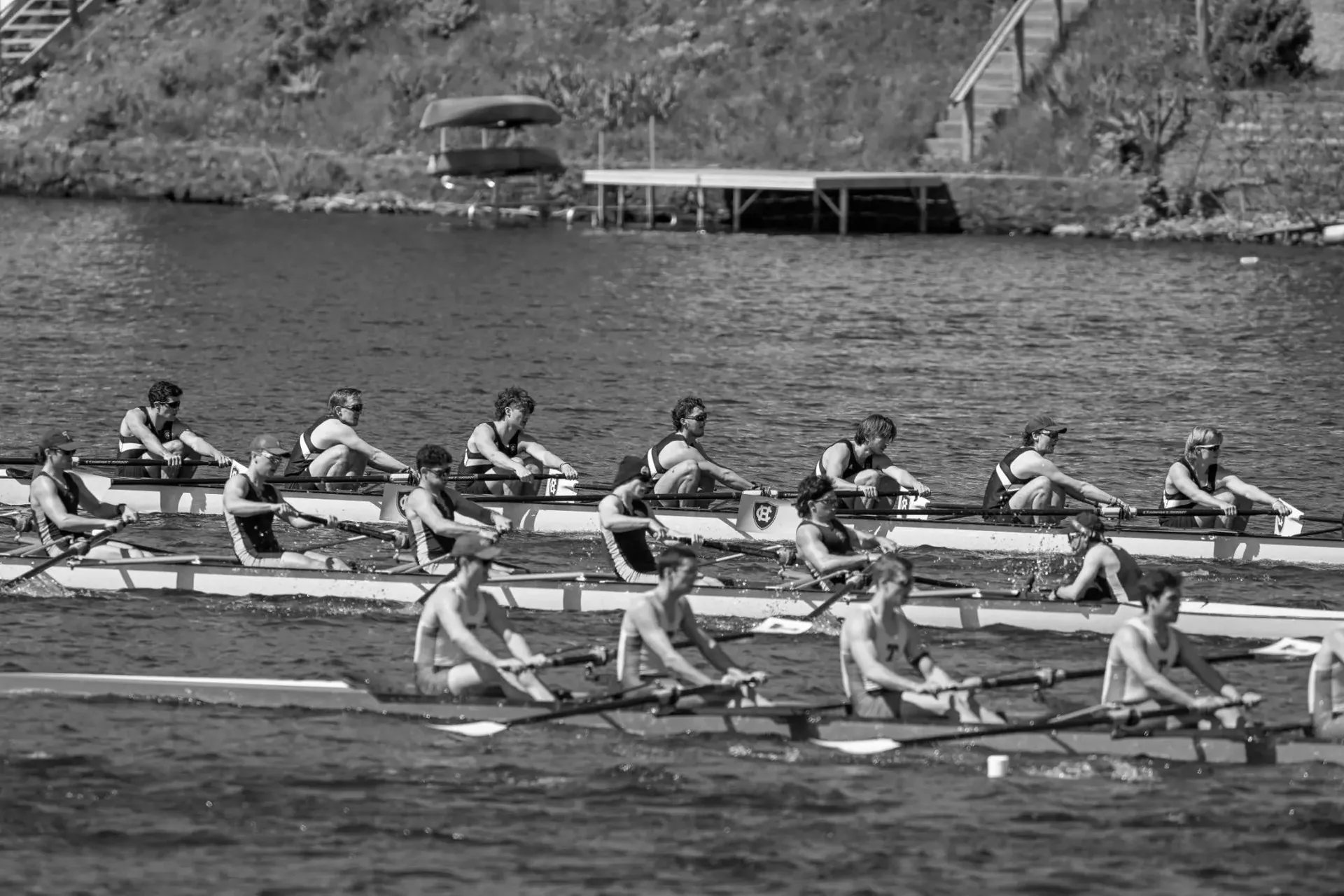 Men’s rowing crews racing side by side on the water.